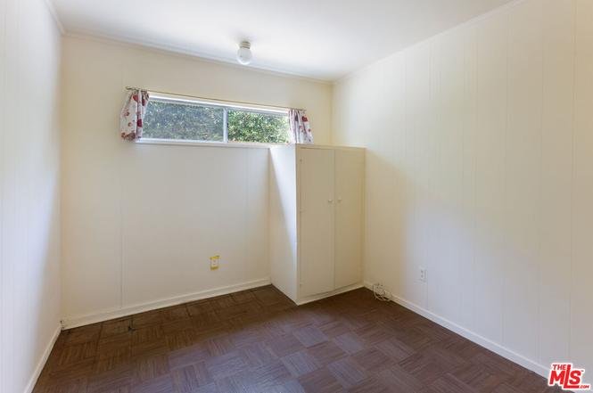 Small room with window, light, cabinet, and dark wood floor