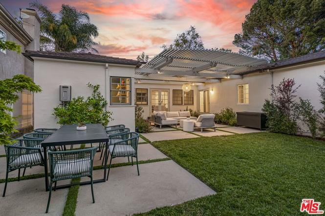California real estate house backyard with patio table, seating area, and garden.