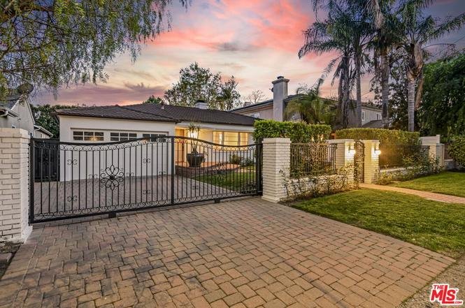Luxury California real estate house with gated entrance and green garden.