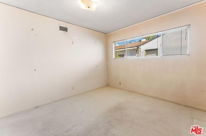 Empty room with bare walls and window.