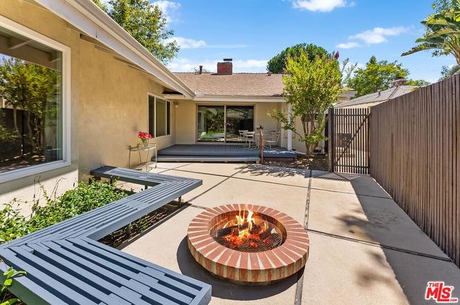 Backyard patio with brick fire pit, seating