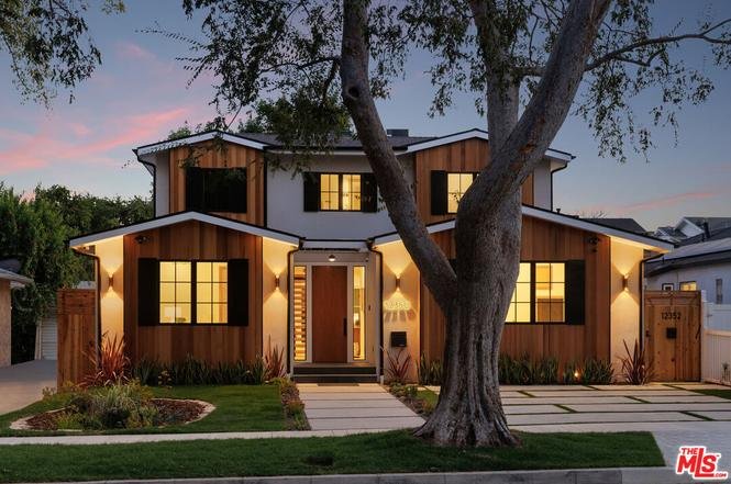California real estate two-story home with wooden exterior, large windows, and landscaped yard
