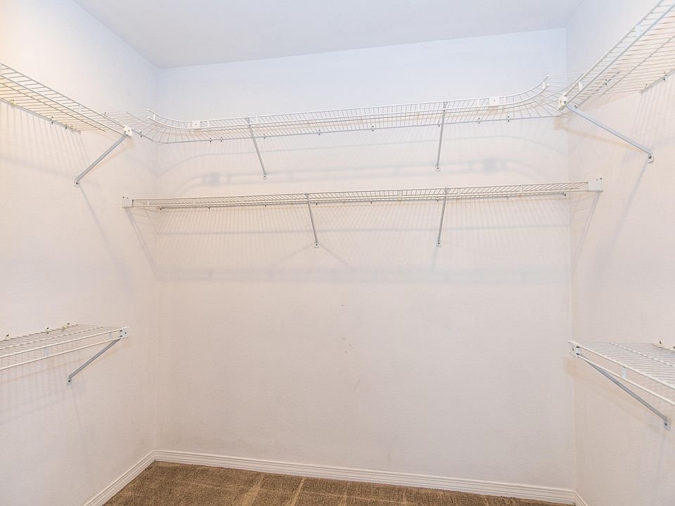 Empty closet with white wire shelves