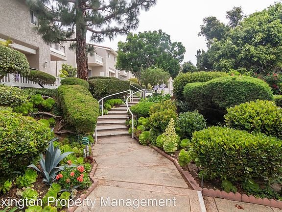 California real estate pathway with shrubs, plants, stairs, and houses