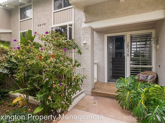 California real estate front entrance with greenery and flowers