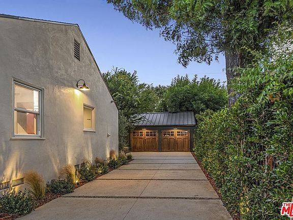 California real estate home with landscaped yard, gravel, plants, and lounge chairs